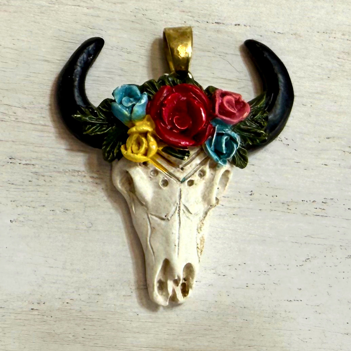 Close-up of floral bull skull western hat charm style 1 with colorful roses and black horns