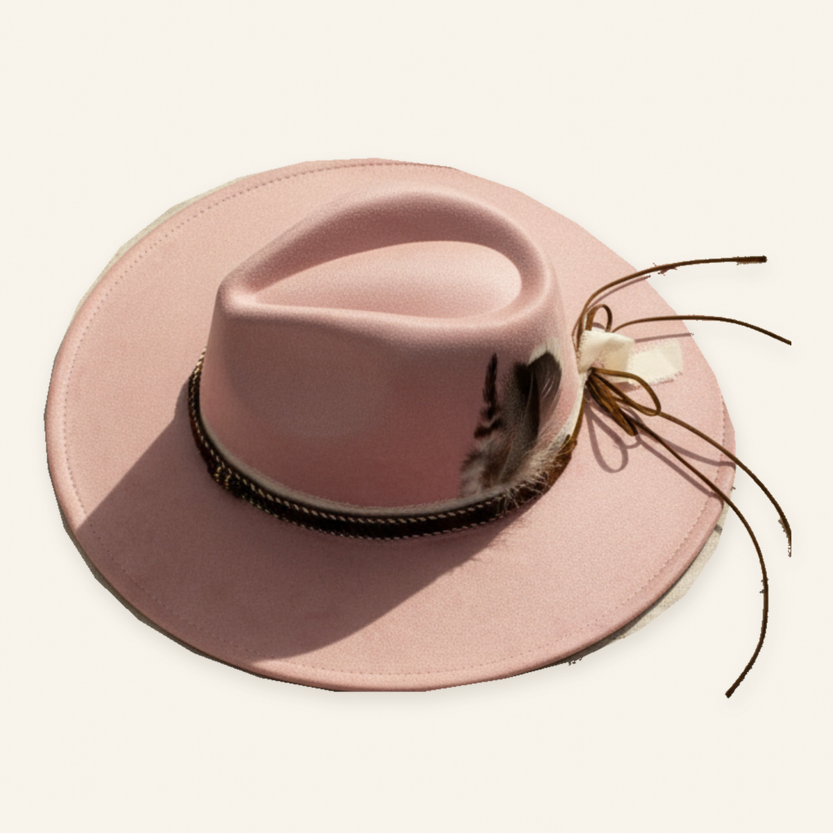 Original dusty pink finished hat with feather cluster, narrow dark band, cream ribbon and brown ties