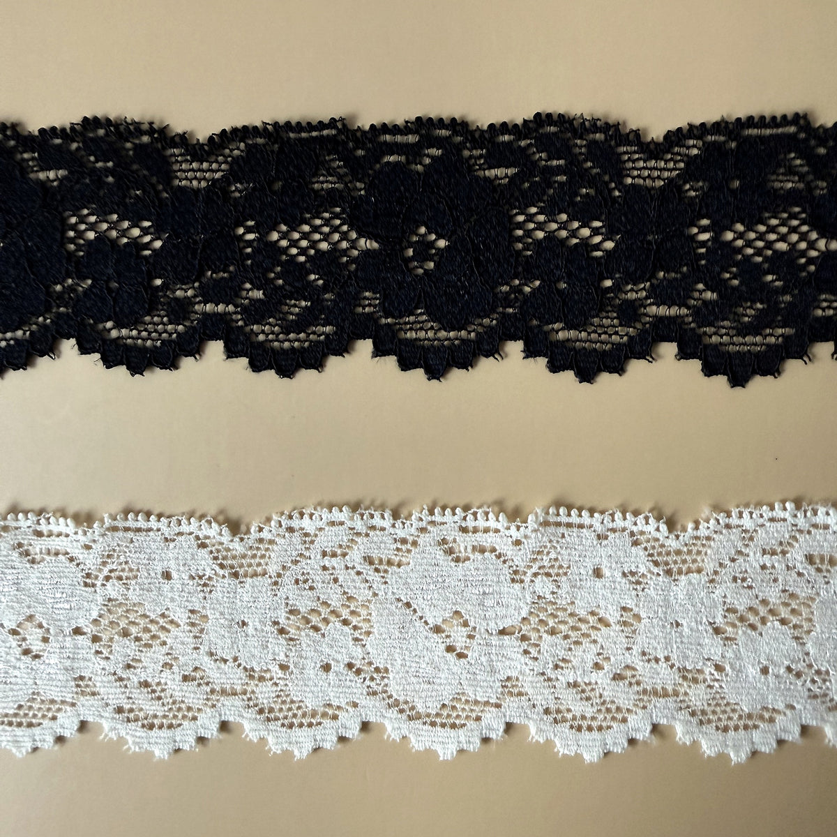 Close-up of black and ivory floral lace western hat ribbons showing texture and detail