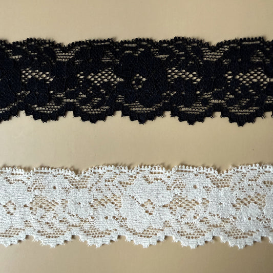 Close-up of black and ivory floral lace western hat ribbons showing texture and detail