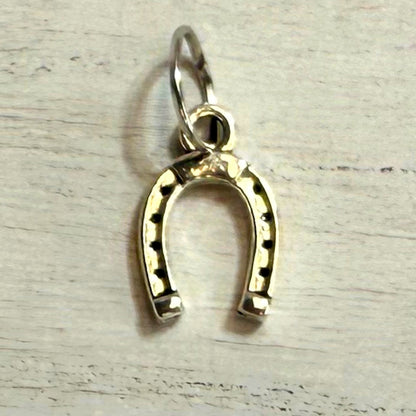 Close-up front view of pink enamel bow western hat charm with gold-tone detail