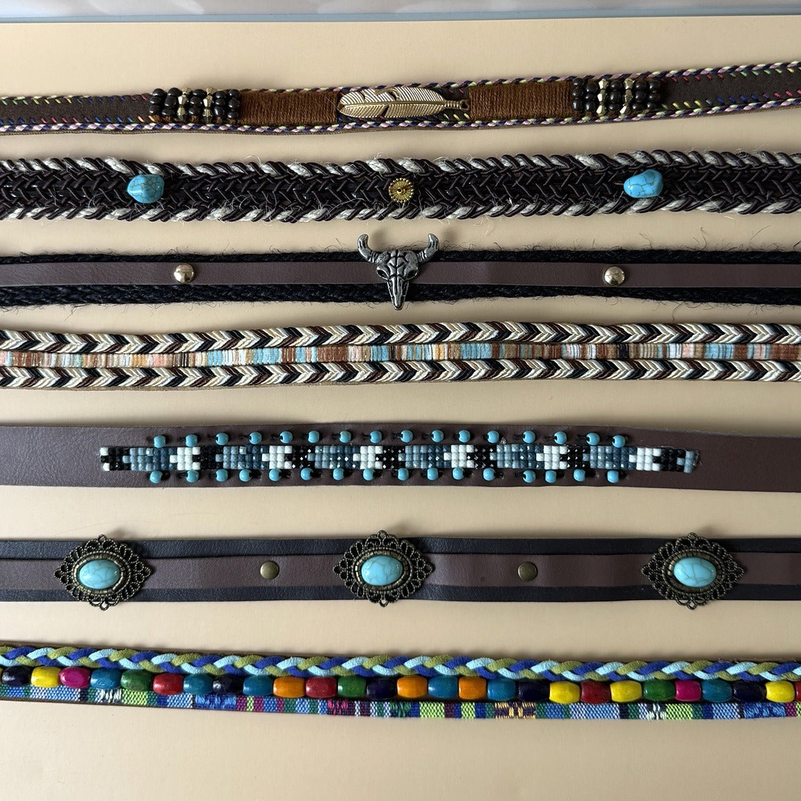 Assorted western hat bands with turquoise, bull skull, braided, beaded and concho details